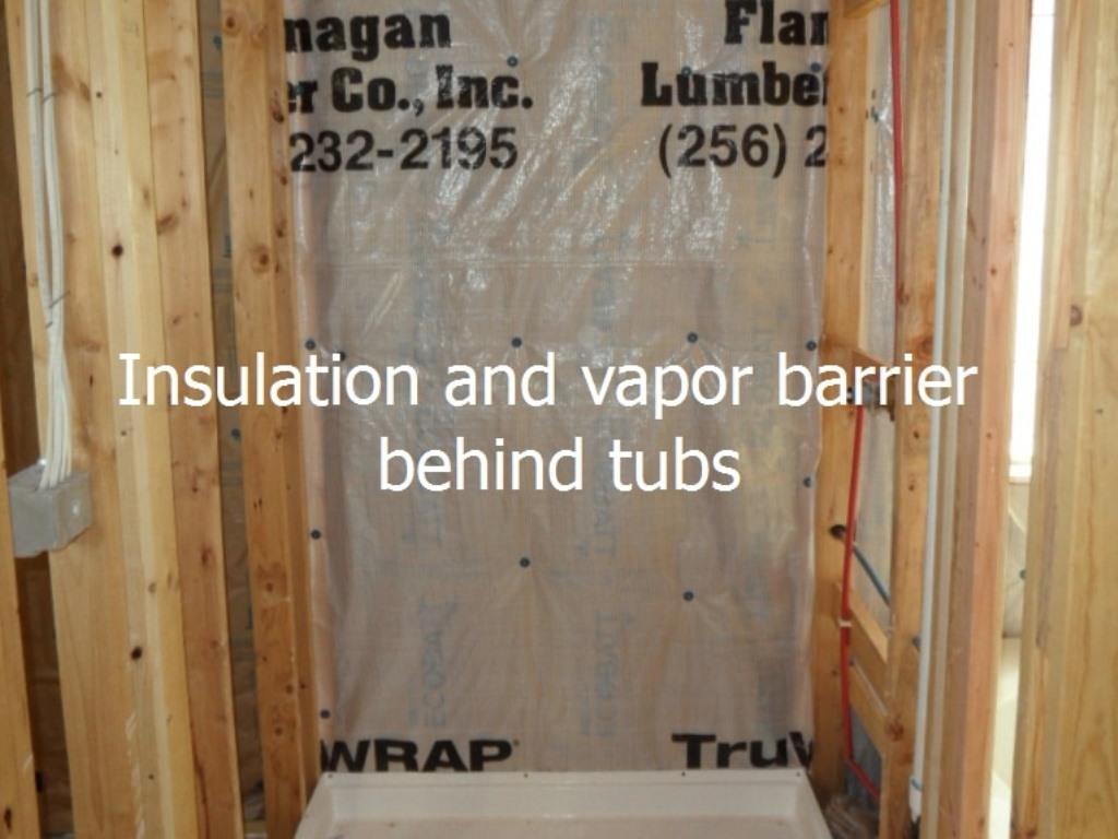 Insulation and vapor barrier behind tubs