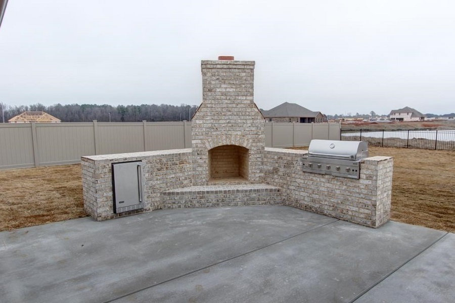 Outside Fireplace with Grill and Refrigerator